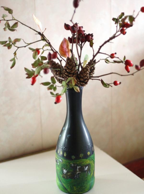 Vase from a bottle with autumn ikebana