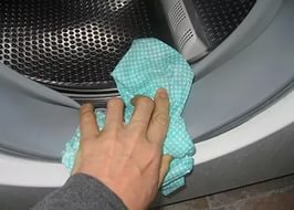 καθαρίζοντας το κόμμι ενός πλυντηρίου ρούχων